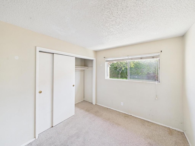 837 Oneonta St, Imperial Beach, CA 91932 - unfurnished bedroom with a textured ceiling, a closet, baseboards, and carpet