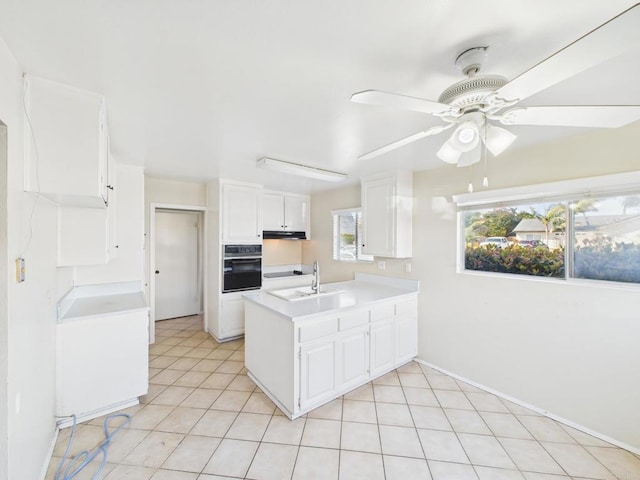837 Oneonta St, Imperial Beach, CA 91932 - kitchen with a peninsula, light tile patterned floors, white cabinetry, a ceiling fan, and oven