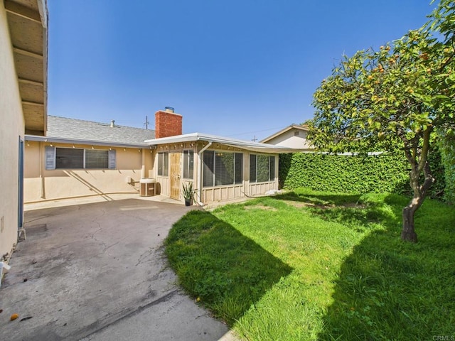 837 Oneonta St, Imperial Beach, CA 91932 - exterior space with a sunroom, a patio area, a lawn, a chimney, and stucco siding