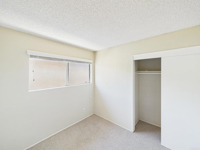 837 Oneonta St, Imperial Beach, CA 91932 - unfurnished bedroom featuring carpet floors, a closet, a textured ceiling, and baseboards