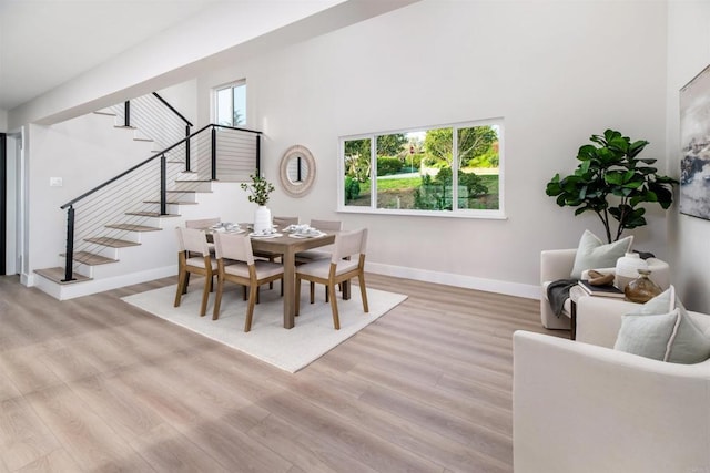 475 Parkwood Ln, Encinitas, CA 92024 - dining room with stairs, light wood finished floors, and a towering ceiling