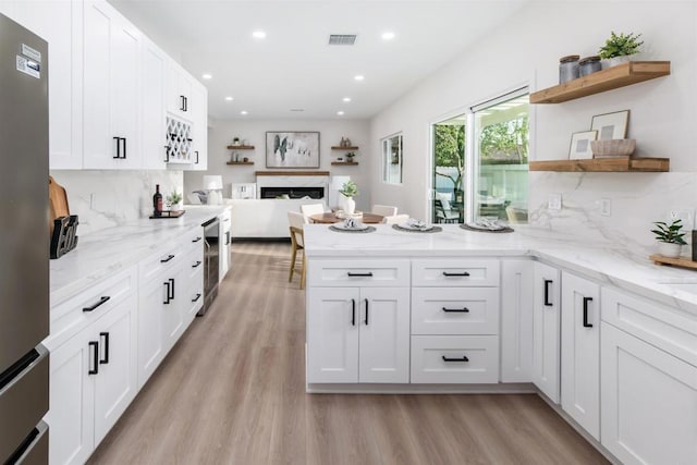 475 Parkwood Ln, Encinitas, CA 92024 - kitchen featuring open shelves, wine cooler, a peninsula, white cabinets, and light wood-style flooring