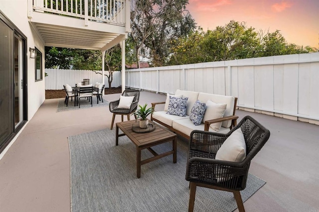 475 Parkwood Ln, Encinitas, CA 92024 - patio terrace at dusk with an outdoor living space, outdoor dining space, a patio area, and a fenced backyard