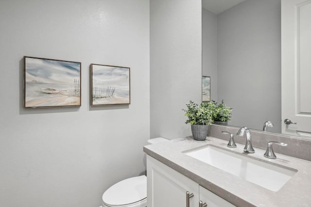 bathroom featuring toilet and vanity