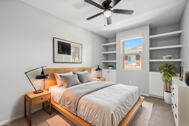 bedroom with light carpet, baseboards, and a ceiling fan