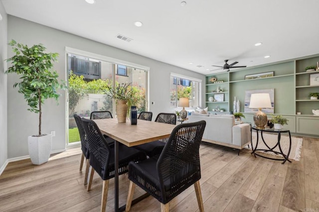dining space with visible vents, light wood finished floors, and recessed lighting