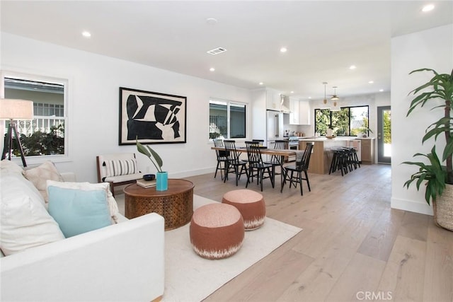 living room with visible vents, recessed lighting, and light wood finished floors