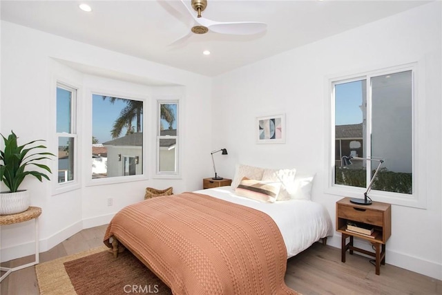 bedroom featuring baseboards, recessed lighting, ceiling fan, and wood finished floors