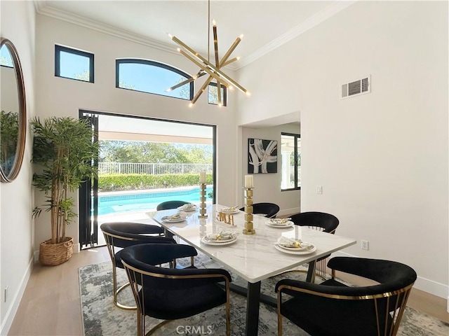 dining area featuring plenty of natural light, visible vents, and crown molding