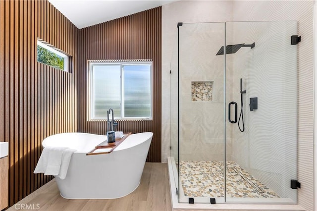 full bathroom featuring a freestanding bath and a stall shower