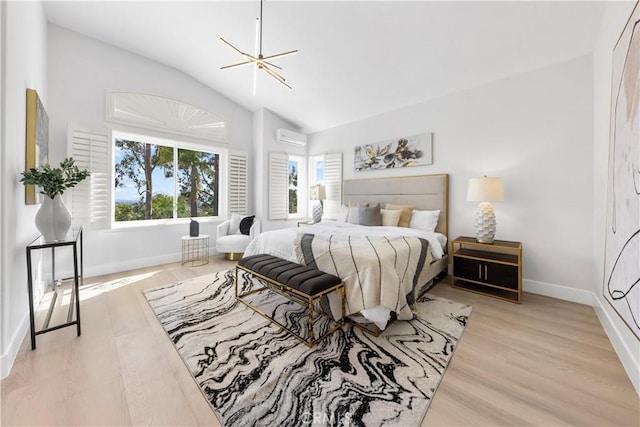 bedroom featuring a wall mounted AC, vaulted ceiling, baseboards, and wood finished floors