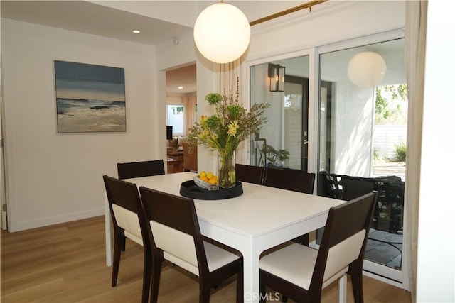 dining area with recessed lighting, baseboards, and light wood-style floors
