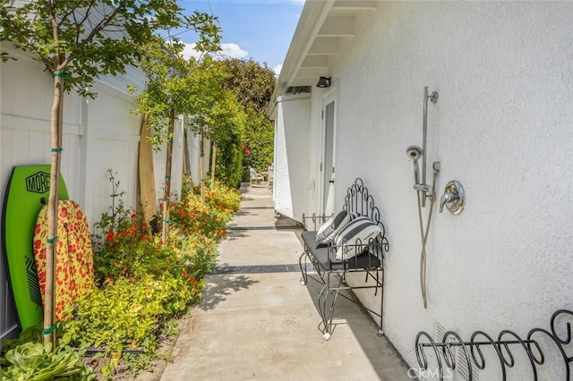 view of side of home with stucco siding