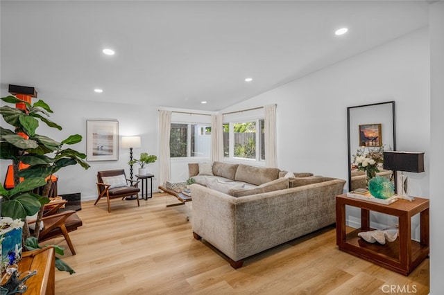 living area with recessed lighting, vaulted ceiling, and light wood-type flooring