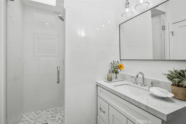 bathroom with vanity and a stall shower