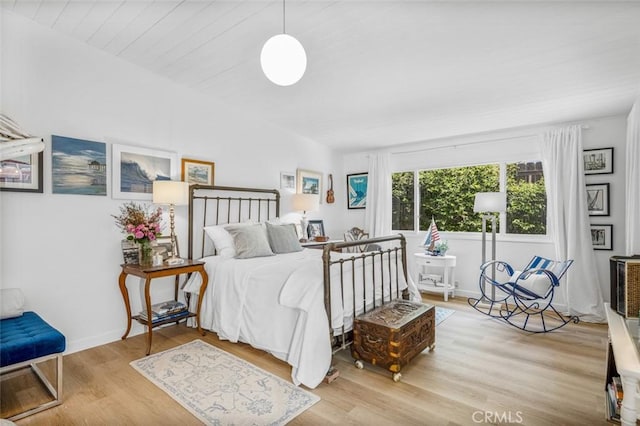 bedroom with baseboards and wood finished floors