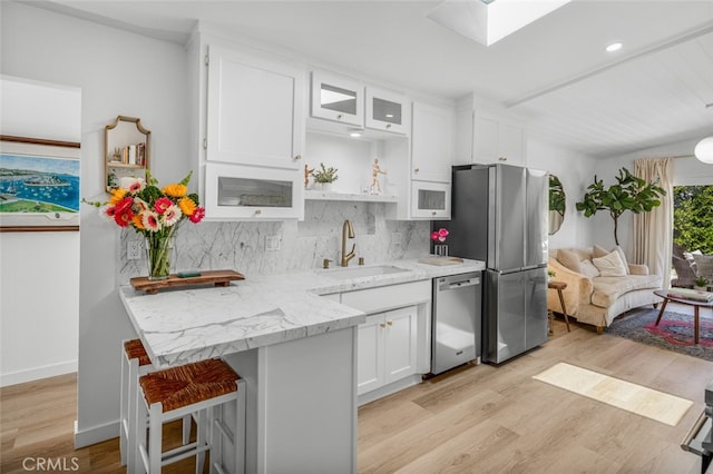 34832 Calle Del Sol, Dana Point, CA 92624 - kitchen with stainless steel appliances, a sink, white cabinetry, light wood-style flooring, and recessed lighting