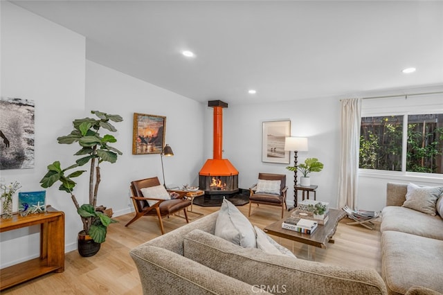 34832 Calle Del Sol, Dana Point, CA 92624 - living room featuring a wood stove, light wood-style flooring, recessed lighting, and baseboards