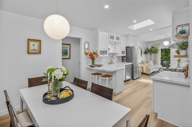 34832 Calle Del Sol, Dana Point, CA 92624 - dining room with a skylight, light wood-type flooring, and recessed lighting