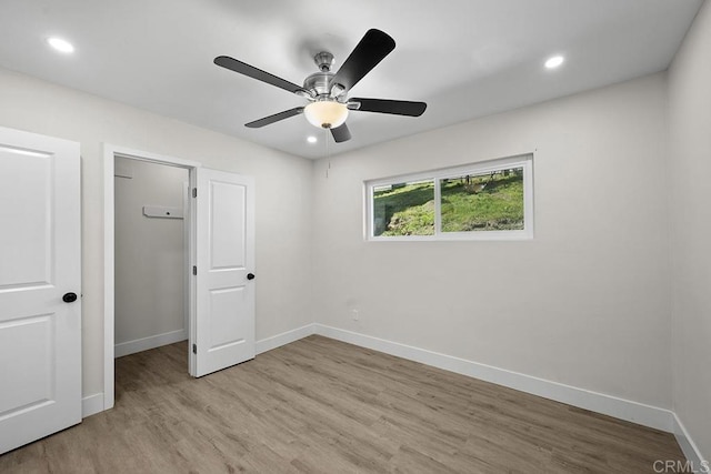 unfurnished bedroom with baseboards, light wood-type flooring, and recessed lighting