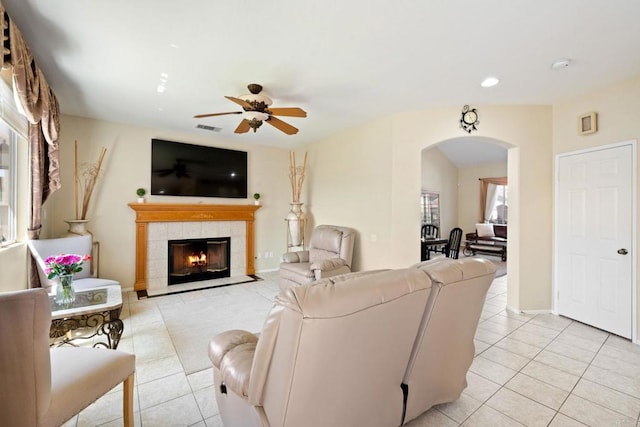 1396 Carneros Valley St, Chula Vista, CA 91913 - living room featuring arched walkways, light tile patterned floors, a ceiling fan, a fireplace, and recessed lighting