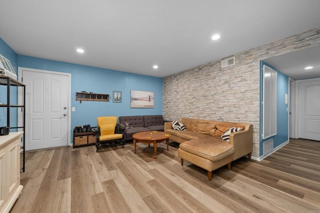 living room featuring recessed lighting, light wood finished floors, and visible vents