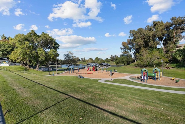 view of home's community featuring playground community and a lawn