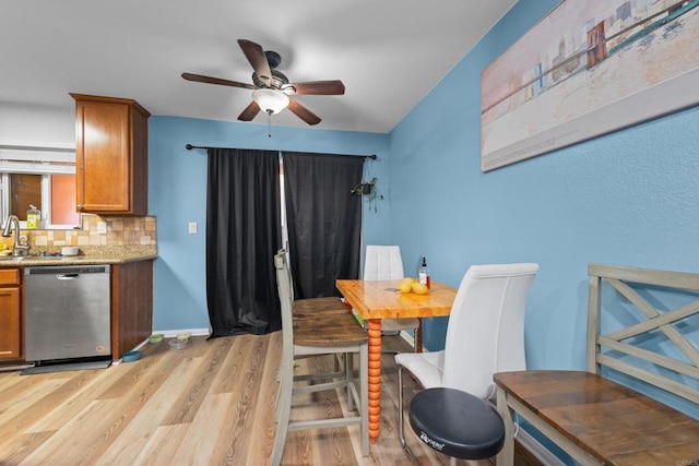 dining space with light wood-style floors, baseboards, and ceiling fan