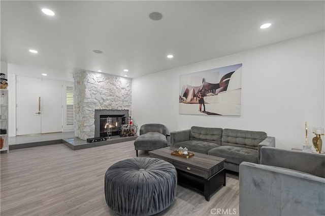 22041 Kinzie St, Chatsworth, CA 91311 - living area featuring wood finished floors, a stone fireplace, and recessed lighting