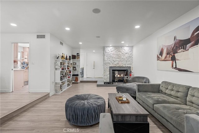 22041 Kinzie St, Chatsworth, CA 91311 - living room featuring a fireplace, light wood-style flooring, recessed lighting, and baseboards