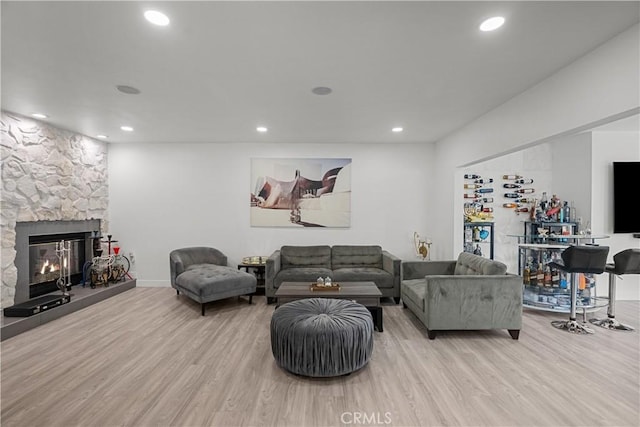 22041 Kinzie St, Chatsworth, CA 91311 - living room featuring wood finished floors, recessed lighting, and a stone fireplace