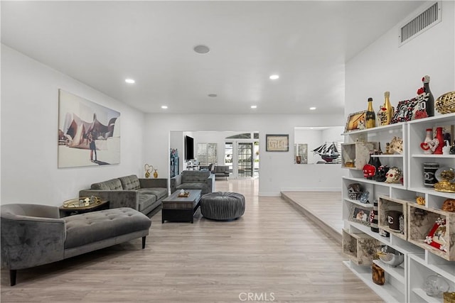 living area featuring light wood-style flooring, visible vents, and recessed lighting