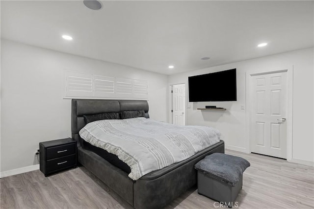 22041 Kinzie St, Chatsworth, CA 91311 - bedroom with light wood finished floors and recessed lighting