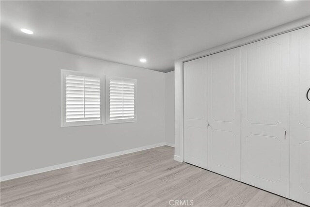 22041 Kinzie St, Chatsworth, CA 91311 - unfurnished bedroom featuring light wood finished floors, a closet, and recessed lighting