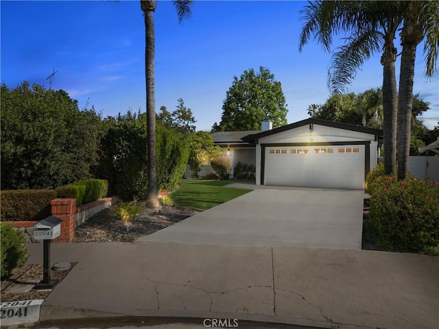 22041 Kinzie St, Chatsworth, CA 91311 - view of front of home featuring a garage and concrete driveway