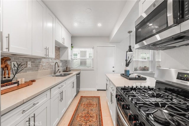 3614 Kalsman Dr Unit 1, Los Angeles, CA 90016 - kitchen with a healthy amount of sunlight, decorative backsplash, a sink, and stainless steel appliances