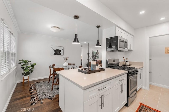 3614 Kalsman Dr Unit 1, Los Angeles, CA 90016 - kitchen with pendant lighting, appliances with stainless steel finishes, light countertops, and white cabinetry
