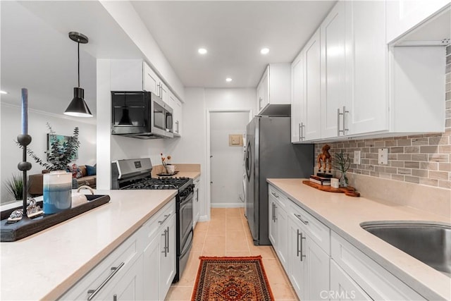 3614 Kalsman Dr Unit 1, Los Angeles, CA 90016 - kitchen with light countertops, white cabinetry, and stainless steel appliances
