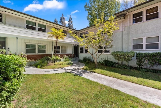 3614 Kalsman Dr Unit 1, Los Angeles, CA 90016 - view of front of home featuring board and batten siding and a front lawn