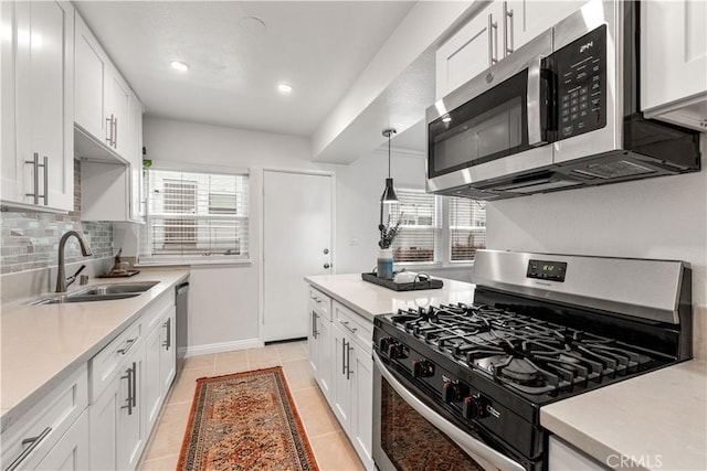 3614 Kalsman Dr Unit 1, Los Angeles, CA 90016 - kitchen with light countertops, appliances with stainless steel finishes, a sink, and white cabinets