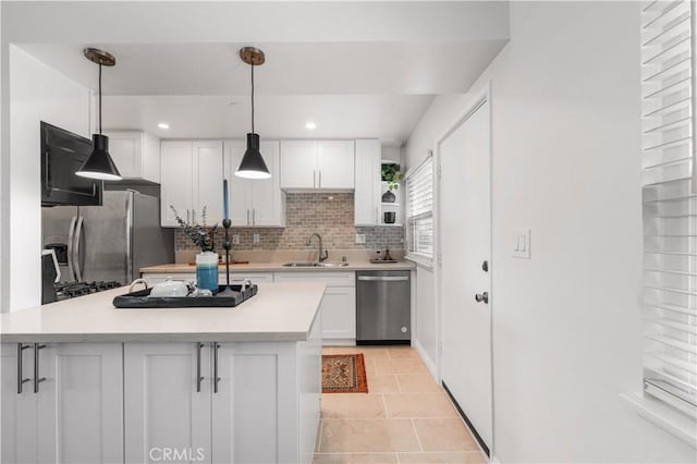 3614 Kalsman Dr Unit 1, Los Angeles, CA 90016 - kitchen featuring light countertops, white cabinets, decorative backsplash, stainless steel appliances, and a sink