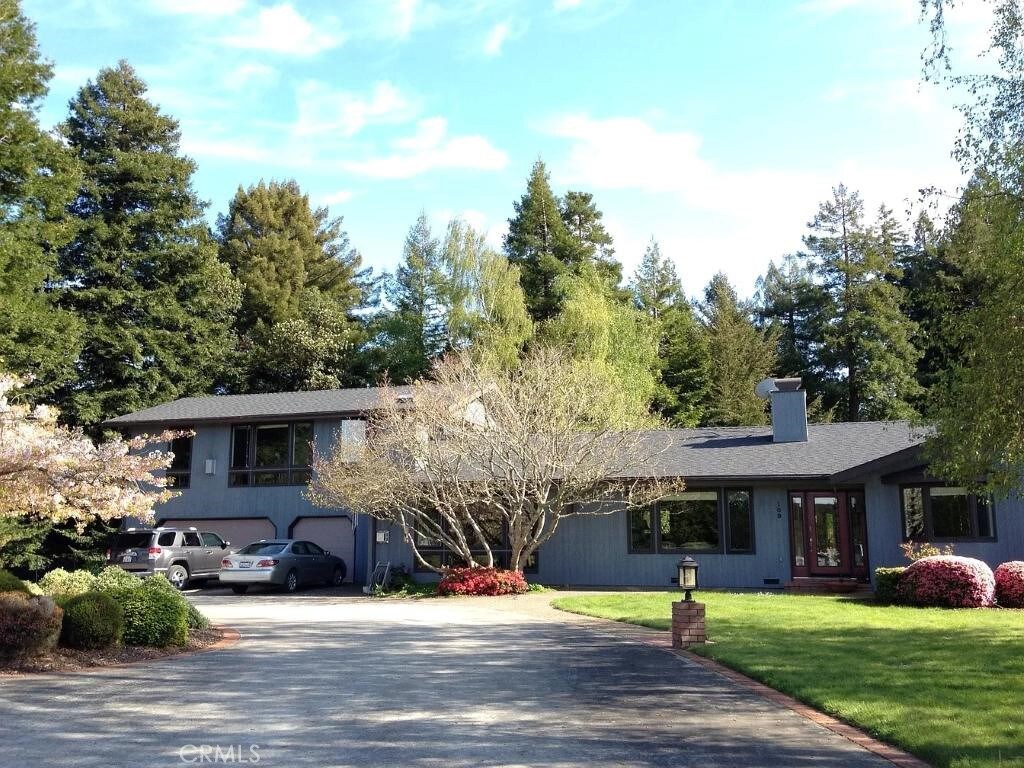 109 Pampas Ln, Fortuna, CA 95540 - tri-level home with a chimney, driveway, french doors, an attached garage, and a front lawn