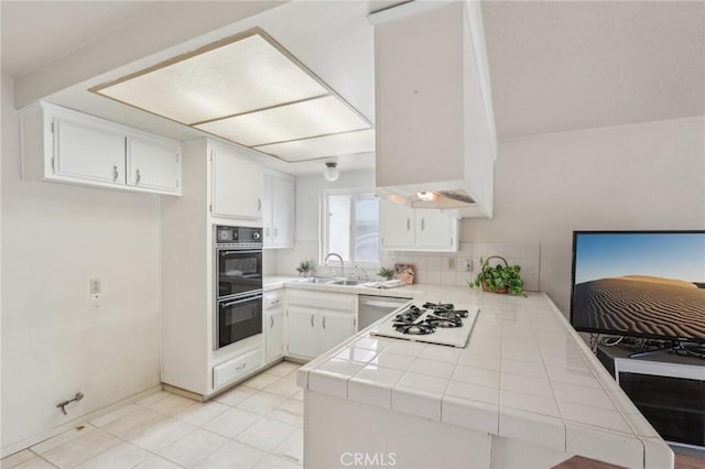 kitchen featuring white gas stovetop, white cabinetry, tile countertops, dishwasher, and dobule oven black