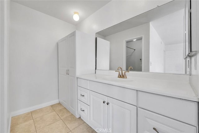 bathroom featuring vanity, baseboards, and tile patterned flooring