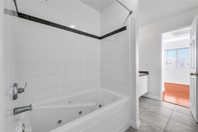 bathroom with vanity, tile patterned flooring, visible vents, and a combined bath / shower with jetted tub