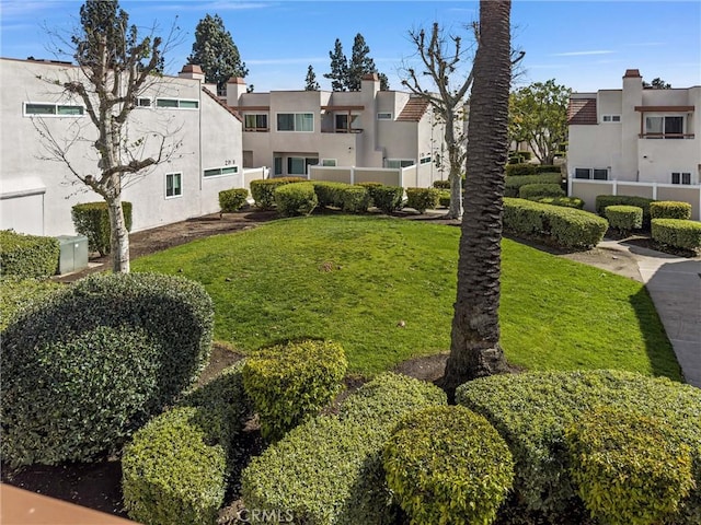 view of community with a yard and a residential view