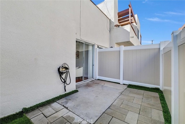 view of patio featuring fence