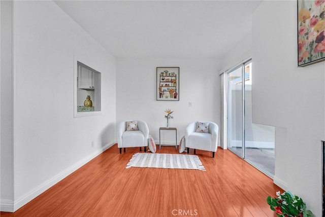 living area with wood finished floors and baseboards