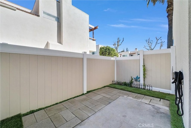 view of patio featuring fence