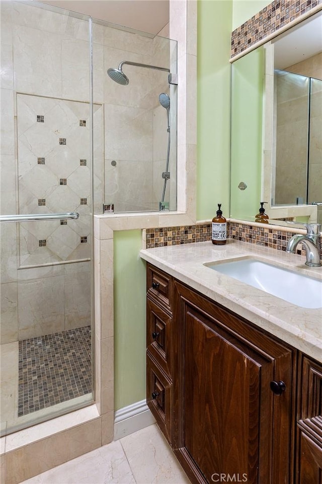 2895 Lorain Rd, San Marino, CA 91108 - full bathroom featuring vanity, decorative backsplash, a shower stall, and marble finish floor